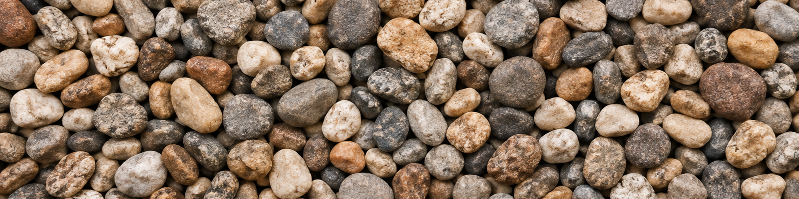 Close up of washed 3/8 inch pea gravel, rounded stones in mixed grey, tan and white.